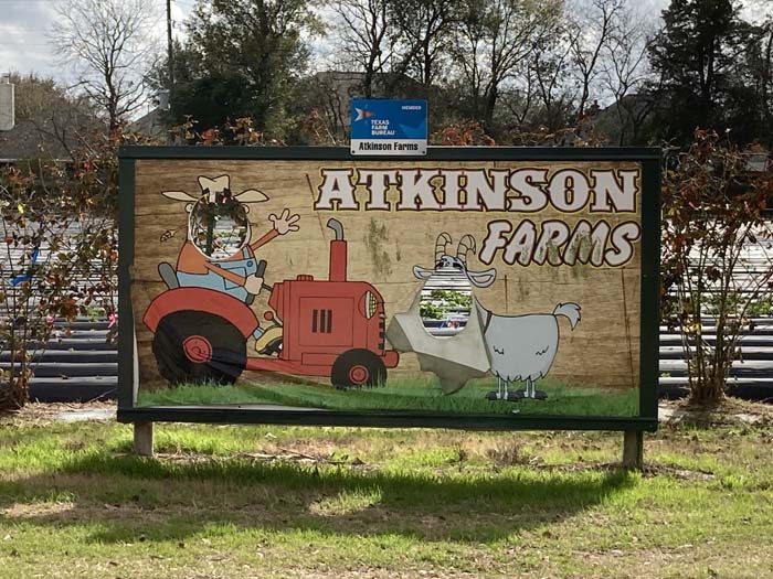 The entrance sign at Atkinson Farms allows guests to pose as a farmer or goat for photos.