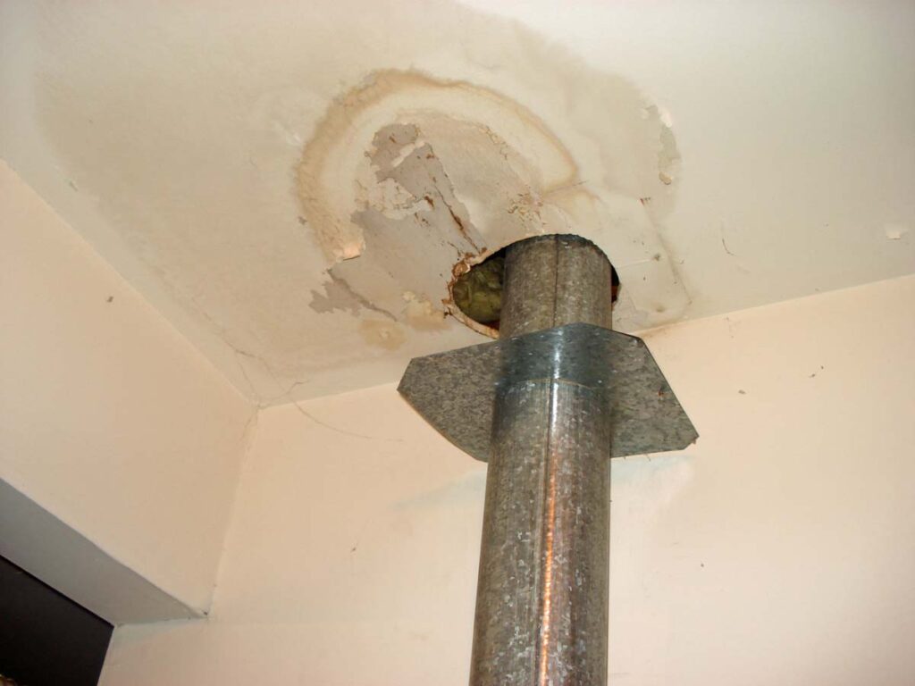 Water from roof leaks can flow down any pipe, vent, or part of the wood frame.