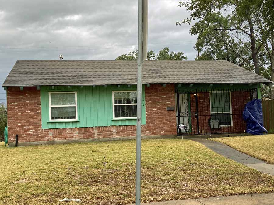 A small 3 bedroom 2 bath house in Houston with distinctive green siding.